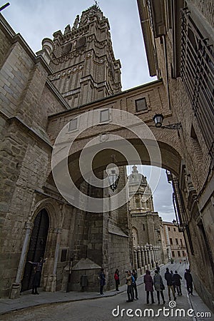 Street of the Arch of Palace next to the tower of the Santa Iglesia Catedral Primada de Toledo Editorial Stock Photo