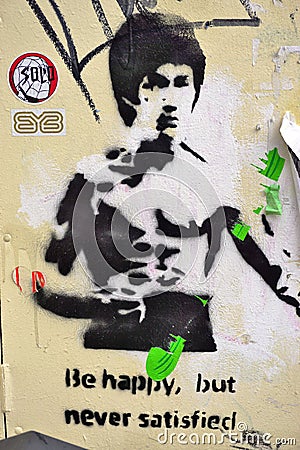 A street art graffiti painting representing martial artist Bruce Lee in London Editorial Stock Photo