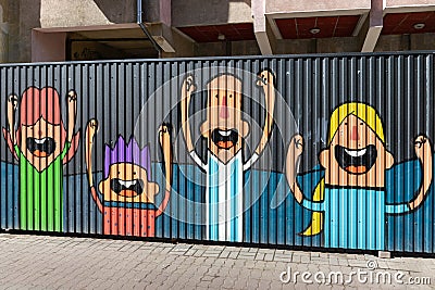 Street art on a metal fence. Cheerful family. Editorial Stock Photo