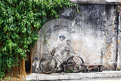 Street Art mural boy and girl on bicycle on a wall in George Town on Penang island in Malaysia Editorial Stock Photo