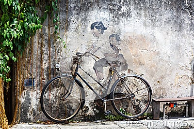 Street Art mural boy and girl on bicycle on a wall in George Town on Penang island in Malaysia Editorial Stock Photo