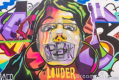 Street art mural showing a woman face and the words Editorial Stock Photo