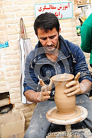 Street artisian making clay pots on pottery wheel Editorial Stock Photo