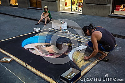 Street artist drawing the Girl with a Pearl Earring on asphalt Editorial Stock Photo