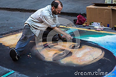 Street artist drawing Mona Lisa on asphalt Editorial Stock Photo