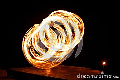 Street artist fire juggling performance. Light painting and long exposure picture to form trails. Phi Phi Island, Thailand. Stock Photo