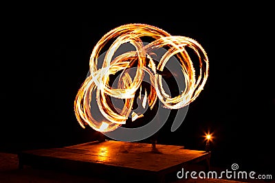 Street artist fire juggling performance. Light painting and long exposure picture to form trails. Phi Phi Island, Thailand. Stock Photo