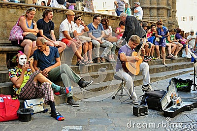 Italians enjoying a summer day in Florence , Italy with street artists and spectators Editorial Stock Photo