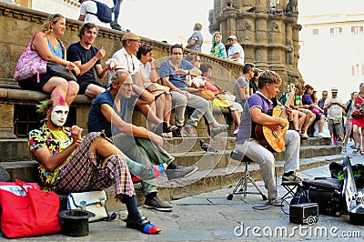 Italians enjoying a summer day in Florence , Italy with street artists and spectators Editorial Stock Photo
