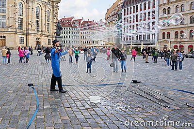 Street artist in the old town of Dresden entertains tourists Editorial Stock Photo