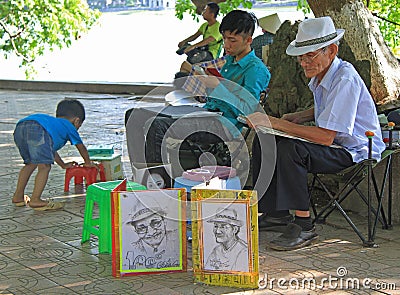 Street artist is painting portrait of someone in Editorial Stock Photo