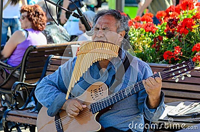 A street artist playing guitar and mouth organ music, san Fransisco Editorial Stock Photo