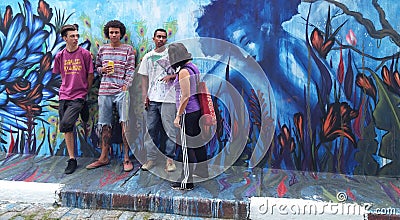Street artists gathered around their blue mural about a woman and nature Editorial Stock Photo