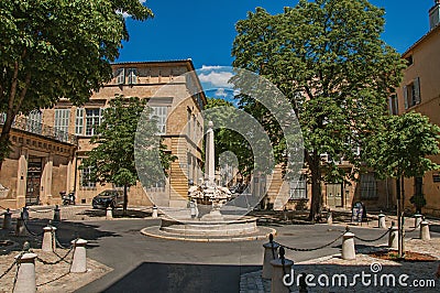 Street with buildings and fountain, sunny afternoon in Aix-en-Provence. Editorial Stock Photo