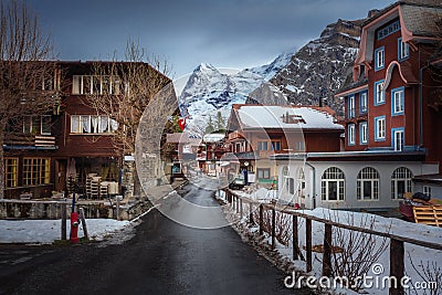 Street and buildings in Murren Village with Eiger Mountain on background - Murren, Switzerland Stock Photo