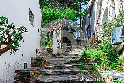 Street in Cadaques, Catalonia, Spain near of Barcelona. Scenic old town with nice beach and clear blue water in bay. Famous Stock Photo