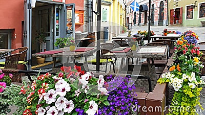 Street cafe table and chair with beautiful flowers in Old town of Tallinn Travel to Estonia tourism in Europa Stock Photo