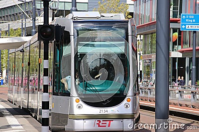 Street cars Trams of the RET in Rotterdam on the streets type Citadis in the Netherlands with buildings and scyscraper Editorial Stock Photo