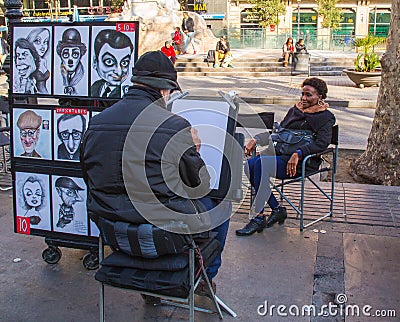 Street cartoonist with model Editorial Stock Photo