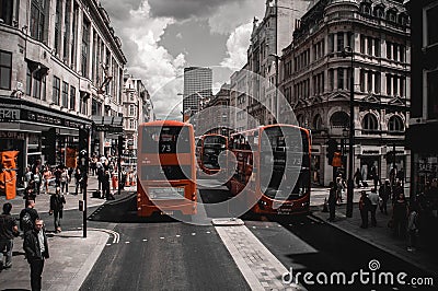 A street in central London. Red double-decker buses between historic buildings. Editorial Stock Photo