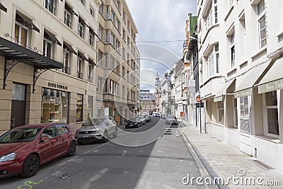 Street with closed shops and parked cars Stock Photo