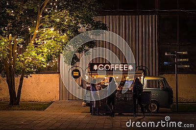 Street coffee shop equipped in a retro van in Sevkabel Port at night Editorial Stock Photo