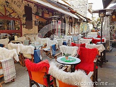 Street coffee shop tables and chairs with warm cloth in Kalari street Ioannina city Stock Photo