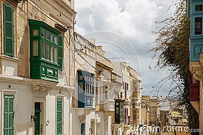 Street with colourful traditional wooden maltese balconies in Sliema, Malta Stock Photo