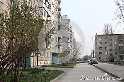 street in the courtyard of modern apartment buildings with parked cars in the city in summer Editorial Stock Photo