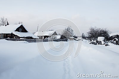Street covered with snow in traditional russian village Stock Photo