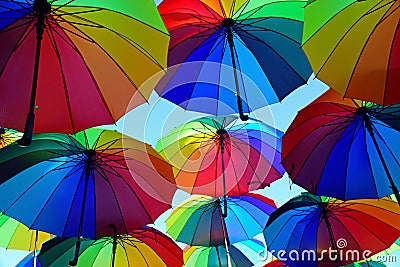 Street decorated with colorful umbrellas to attract customers and tourists Stock Photo