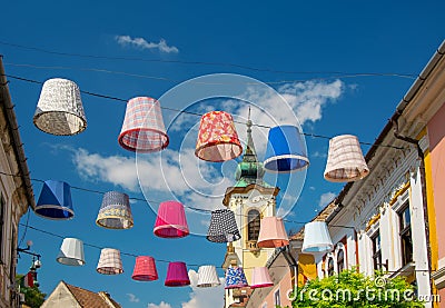 Street decoration of plenty colorful lampshades in old town of Szentendre, Hungary at sunny summer day Stock Photo