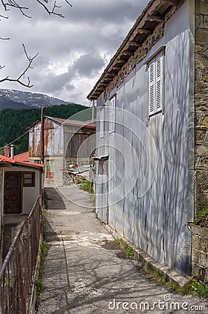 Street and facade of a house in Milia village, near Metsovo, Greece Stock Photo