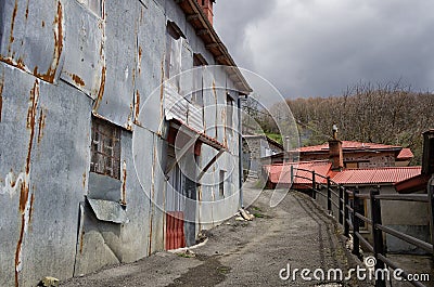 Street and facade of a house in Milia village, near Metsovo, Greece Stock Photo