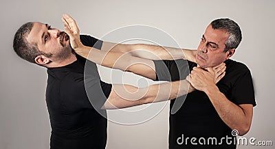 Street fighting self defense technique against holds and grabs Stock Photo