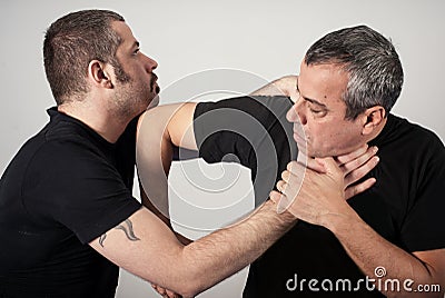 Street fighting self defense technique against holds and grabs Stock Photo