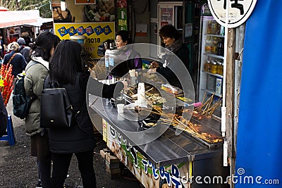 Street food market and souvenirs gifts shop bazaar for korean people travelers travel shopping select buy eat drink after visit at Editorial Stock Photo