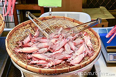 Pile of steamed squid on threshing basket at street food in Taipei, Taiwan Stock Photo