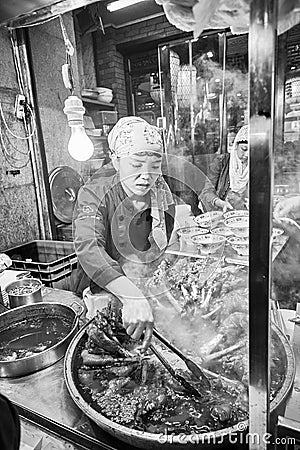 Street food preparation in the Muslim Quarter. Editorial Stock Photo