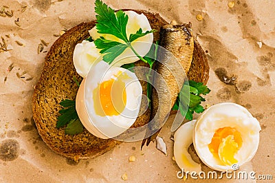 Street food sandwich with egg and sardines on paper Stock Photo