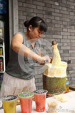 Street food seller is cutting durian in China Editorial Stock Photo