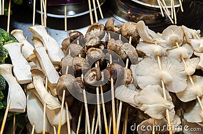 Street food stall with mushroom on sticks, different types - porcini, champignon, Oyster. Stock Photo
