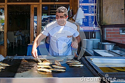 Street food vendor cooking fish Editorial Stock Photo