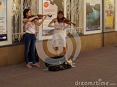 Street girls musicians playing violins Editorial Stock Photo