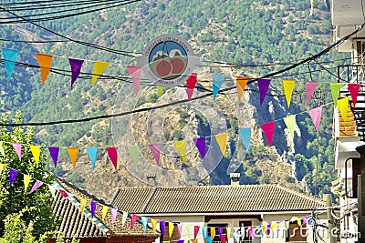 A street in GÃºÃ©jar-Sierra Spain adorned with colored banners in celebration of Editorial Stock Photo