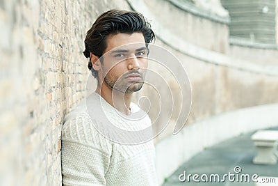 Street handsome man, urban style. Leaning on a wall. Outdoor Stock Photo