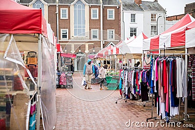 the street has several tents on it next to houses and buildings Editorial Stock Photo