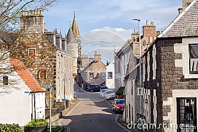 Street in the historic village of Falkland in Scotland, home of Falkland Palace. Cars parked along the road Editorial Stock Photo