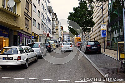 Street with houses of mid-20th century and modern cars Editorial Stock Photo