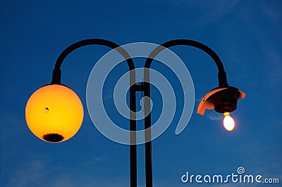 Street lamp with a broken shade Stock Photo